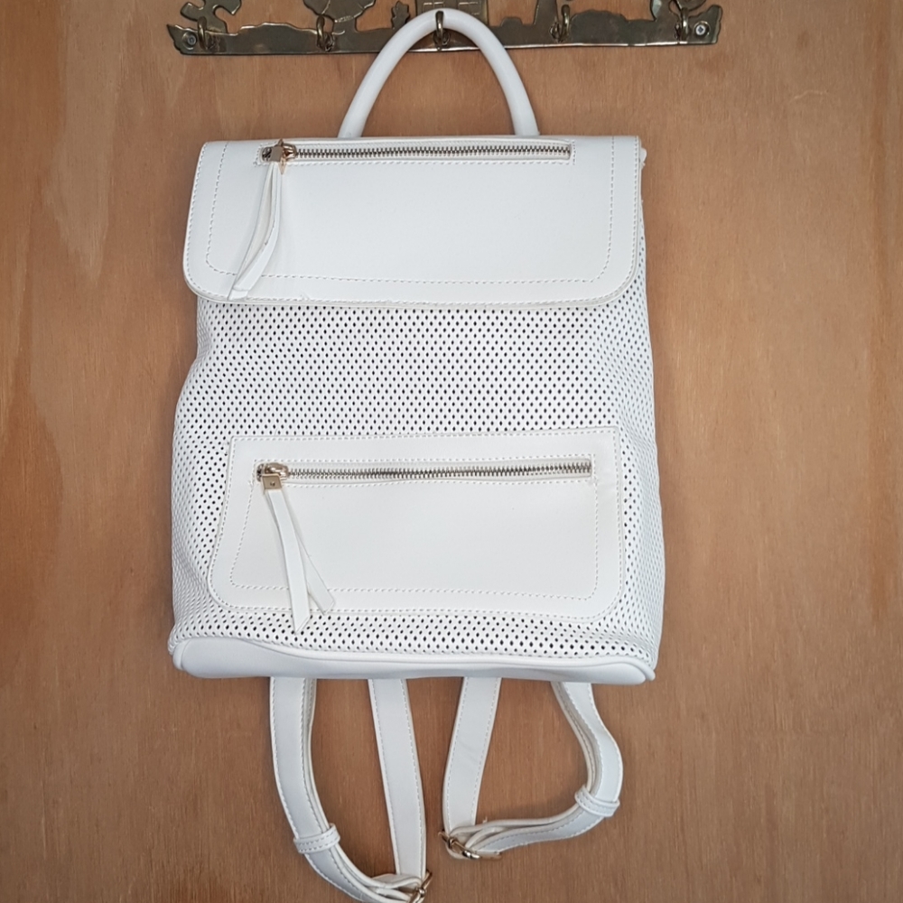 White perforated pleather small backpack.